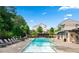 A refreshing community pool surrounded by lush greenery and seating areas at 310 Braeden Way, Alpharetta, GA 30009