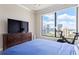Bedroom featuring city views through a large window and a modern Peloton exercise bike at 3445 Stratford Ne Rd # 2409, Atlanta, GA 30326