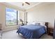 Bright bedroom showcasing a large window with city views, comfortable bed, and ceiling fan at 3445 Stratford Ne Rd # 2409, Atlanta, GA 30326