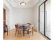 Charming dining area with hardwood floors, modern lighting, and sliding glass doors to a balcony at 3445 Stratford Ne Rd # 2409, Atlanta, GA 30326
