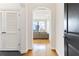 Bright condo hallway featuring hardwood floors and an archway to a living room with city views at 3445 Stratford Ne Rd # 2409, Atlanta, GA 30326