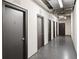 Hallway of condo building featuring multiple unit entry doors and overhead lighting at 3445 Stratford Ne Rd # 2409, Atlanta, GA 30326