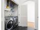 Well-organized laundry closet with modern washer and dryer and shelving for supplies at 3445 Stratford Ne Rd # 2409, Atlanta, GA 30326