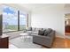 Comfortable living room with hardwood floors and a stunning city view at 3445 Stratford Ne Rd # 2409, Atlanta, GA 30326