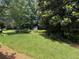 Picturesque backyard with green lawn and mature trees, creating a peaceful outdoor space at 3545 Manchester Dr, Lawrenceville, GA 30044