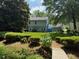 Well maintained backyard with lush landscaping, mature trees, and charming two-story home at 3545 Manchester Dr, Lawrenceville, GA 30044