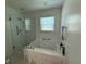 Bright bathroom featuring a tiled shower, jacuzzi tub, and neutral finishes at 3545 Manchester Dr, Lawrenceville, GA 30044