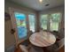 Cozy breakfast nook area with a marble-top table, natural light, and French doors opening to the outdoor space at 3545 Manchester Dr, Lawrenceville, GA 30044