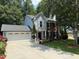 This home boasts a two-car garage, landscaped front yard, and a blend of siding and brick exterior at 3545 Manchester Dr, Lawrenceville, GA 30044