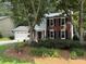 Exterior view of the house showcasing its brick and siding facade and a well-maintained front yard at 3545 Manchester Dr, Lawrenceville, GA 30044