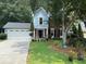 Charming home featuring a two-car garage, manicured lawn, and a mix of brick and siding facade at 3545 Manchester Dr, Lawrenceville, GA 30044