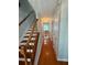 Well-lit hallway featuring hardwood floors, stairs with wooden banisters, and white doors, creating a welcoming entrance at 3545 Manchester Dr, Lawrenceville, GA 30044