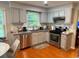 Bright kitchen with granite countertops, stainless steel appliances, ample cabinetry and hardwood floors at 3545 Manchester Dr, Lawrenceville, GA 30044