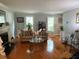 Spacious living room featuring a fireplace, hardwood floors, a comfortable sofa, and bright windows at 3545 Manchester Dr, Lawrenceville, GA 30044
