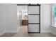 Bedroom featuring a modern barn door, leading to a bathroom with wood vanity at 528 Pumpkinvine Rd, Acworth, GA 30101