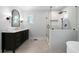 Modern bathroom with dual vanity, glass shower, and soaking tub at 528 Pumpkinvine Rd, Acworth, GA 30101