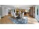 Open dining room with hardwood floors, chandelier, and view into modern kitchen at 528 Pumpkinvine Rd, Acworth, GA 30101