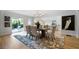 Dining room features a modern chandelier and an outdoor patio view at 528 Pumpkinvine Rd, Acworth, GA 30101