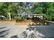 Home with an expansive driveway, mature landscaping, and a charming front facade at 528 Pumpkinvine Rd, Acworth, GA 30101