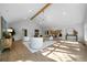 Bright open-concept living room with vaulted ceilings, hardwood floors, and modern chandelier at 528 Pumpkinvine Rd, Acworth, GA 30101