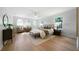 Serene main bedroom with natural light, hardwood floors, sitting area, and neutral decor at 528 Pumpkinvine Rd, Acworth, GA 30101