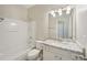 Clean bathroom with granite vanity top, bright lighting, tub and shower combination, and neutral decor at 6755 Waveland Dr, Cumming, GA 30040
