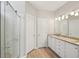 Bathroom with double vanity, granite countertop, and glass shower at 6755 Waveland Dr, Cumming, GA 30040