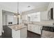 Updated kitchen with granite countertops, white cabinets and stainless appliances at 6755 Waveland Dr, Cumming, GA 30040