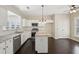 Kitchen boasts granite counters, stainless steel appliances, and island seating at 6755 Waveland Dr, Cumming, GA 30040