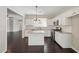 Bright kitchen with white cabinets, granite countertops, stainless steel appliances and island at 6755 Waveland Dr, Cumming, GA 30040