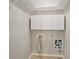 Functional laundry room with cabinetry, bright lighting, and connections for washer and dryer at 6755 Waveland Dr, Cumming, GA 30040