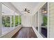 Sunroom with multiple windows and a ceiling fan at 6755 Waveland Dr, Cumming, GA 30040