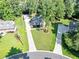 Aerial view showcases a well-maintained property with a long driveway and lush landscaping at 70 Maplewood Ln, Acworth, GA 30101