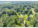 A high angle shows the property nestled among dense trees and neighboring homes within the residential community at 70 Maplewood Ln, Acworth, GA 30101