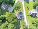 An aerial view shows the property's position in a lush, wooded area, surrounded by trees and foliage at 70 Maplewood Ln, Acworth, GA 30101