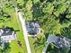 An aerial view of a home surrounded by lush trees, showing the driveway and the neighboring properties at 70 Maplewood Ln, Acworth, GA 30101
