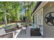 Inviting back deck with comfortable outdoor seating and a view of the landscaped backyard at 70 Maplewood Ln, Acworth, GA 30101