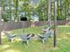 Backyard seating area with a fire pit and string lights creating a cozy outdoor space for relaxation and entertainment at 70 Maplewood Ln, Acworth, GA 30101