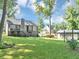 Expansive backyard features a wooden deck, lush green lawn, and a convenient storage building at 70 Maplewood Ln, Acworth, GA 30101