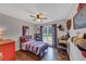 Comfortable bedroom with hardwood floors, a ceiling fan, and a cozy red, white, and blue bed at 70 Maplewood Ln, Acworth, GA 30101