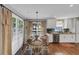 Cozy dining area with table set for four, natural light, and hardwood floors at 70 Maplewood Ln, Acworth, GA 30101