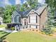 Charming two-story home with well-maintained lawn, colorful flowerbeds, and mature trees at 70 Maplewood Ln, Acworth, GA 30101