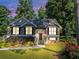 Charming two-story home with well-maintained lawn, colorful flowerbeds, and mature trees at 70 Maplewood Ln, Acworth, GA 30101