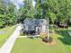 Beautiful home with manicured lawn, mature trees, and a long driveway leading to a detached garage at 70 Maplewood Ln, Acworth, GA 30101