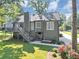 Rear exterior view of home with a deck, stairs, and a well-manicured yard at 70 Maplewood Ln, Acworth, GA 30101