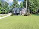 Charming two-story home with well-maintained lawn, colorful flowerbeds, and mature trees at 70 Maplewood Ln, Acworth, GA 30101