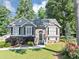 Charming two-story home with well-maintained lawn, colorful flowerbeds, and mature trees at 70 Maplewood Ln, Acworth, GA 30101