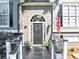Close up of the front porch and door area with black and white railings and columns at 70 Maplewood Ln, Acworth, GA 30101