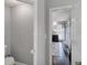 View from hallway into Bedroom with hardwood floors, neutral walls, and ensuite bath at 70 Maplewood Ln, Acworth, GA 30101