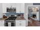 Updated kitchen with stainless appliances, granite counters, and blue tile backsplash at 70 Maplewood Ln, Acworth, GA 30101